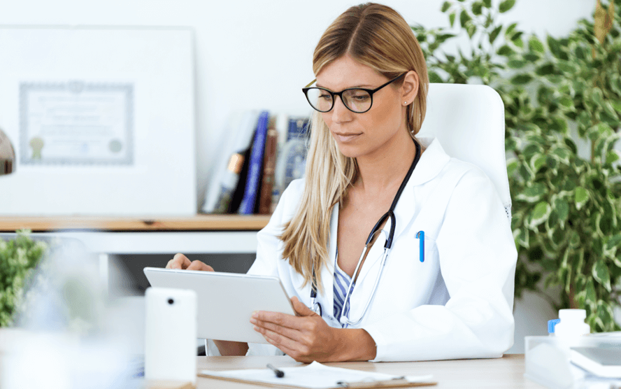 Healthcare professional looking at an ipad.